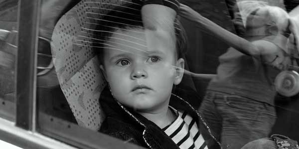 A child strapped safely into a child seat